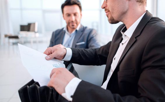 close up.businessman is analyzing financial report.business concept