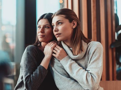 Diverse girls lesbian couple hugging. Close up portrait. Stylish cool generation z women dating in love enjoy romantic relationships. Lgbtq concept.