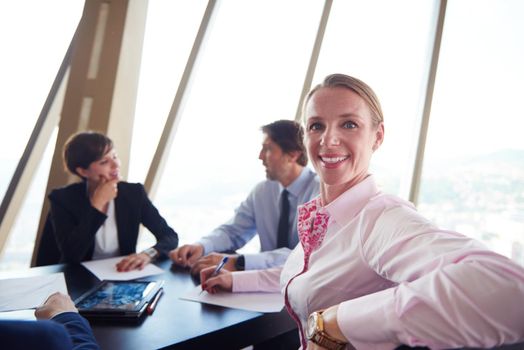 business woman on meeting, people group in background at modern bright office indoors