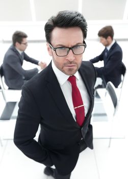 close up.serious businessman standing in the conference room.business concept