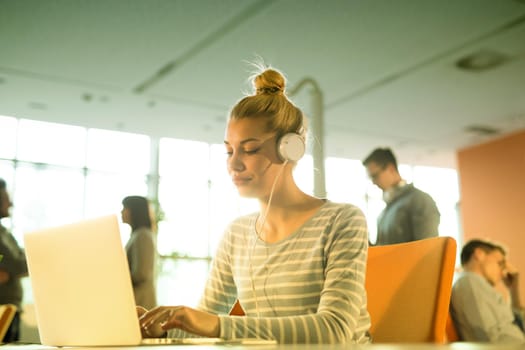 Young female Entrepreneur Freelancer Working Using A Laptop In Coworking space