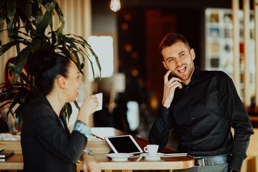 two young people on a break from work in a cafe