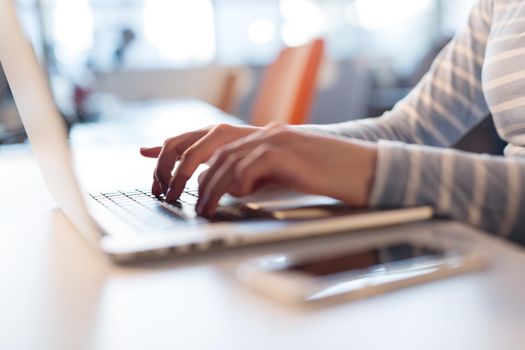 Young female Entrepreneur Freelancer Working Using A Laptop In Coworking space