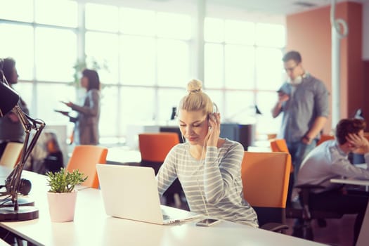 Young female Entrepreneur Freelancer Working Using A Laptop In Coworking space