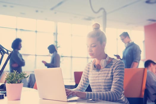 Young female Entrepreneur Freelancer Working Using A Laptop In Coworking space