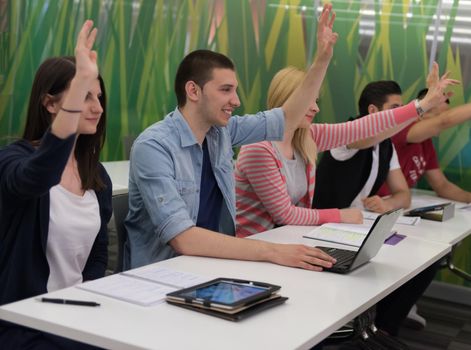 teacher teaching lessons, smart students group raise hands up in school  classroom