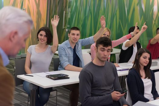 teacher teaching lessons, smart students group raise hands up in school  classroom