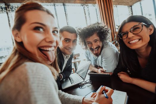 an entertaining portrait of young entrepreneurs sitting in a modern office and using modern devices