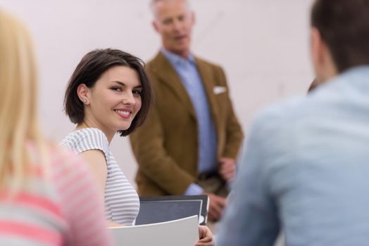 group of students study with professor in modern school classroom