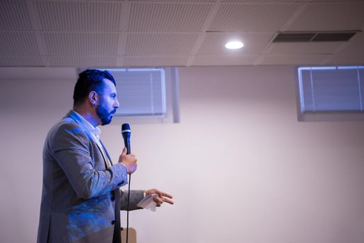 young successful businessman at business conference room with public giving presentations. Audience at the conference hall. Entrepreneurship club