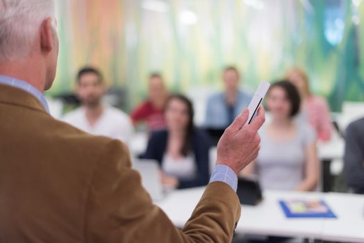 group of students study with professor in modern school classroom