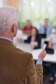 group of students study with professor in modern school classroom