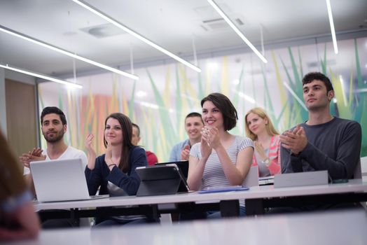 group of students study with professor in modern school classroom