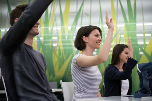 teacher teaching lessons, smart students group raise hands up in school  classroom