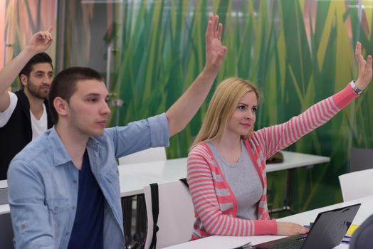 teacher teaching lessons, smart students group raise hands up in school  classroom