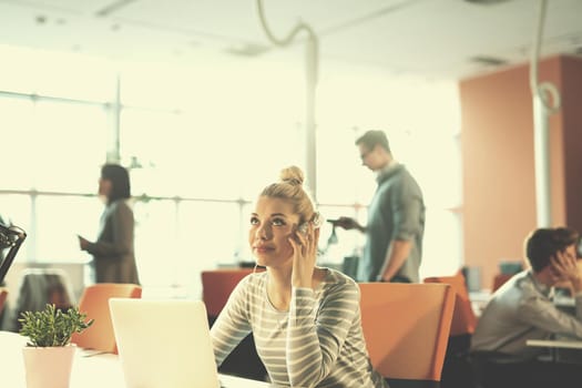 Young female Entrepreneur Freelancer Working Using A Laptop In Coworking space