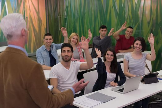 teacher teaching lessons, smart students group raise hands up in school  classroom