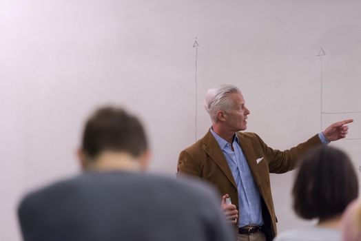 group of students study with professor in modern school classroom