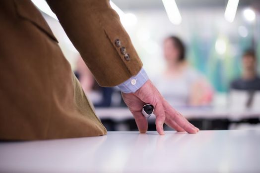 close up of teacher hand with marker while teaching lessons in school  classroom to students