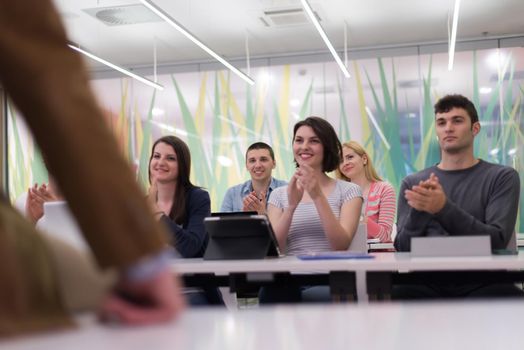 group of students study with professor in modern school classroom