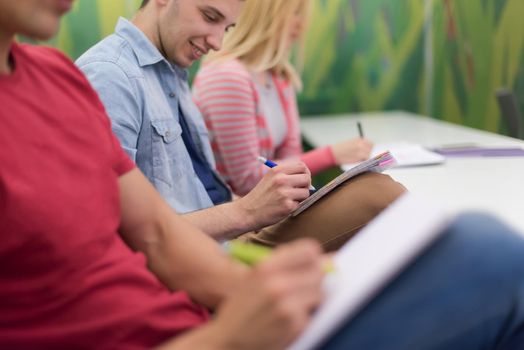 male student taking notes in classroom. business education concept, casual young businessman on seminar training