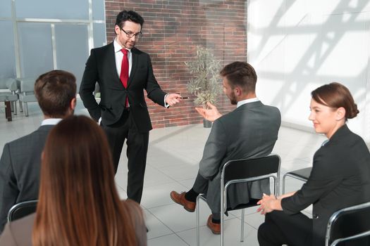 man standing in front talking to a group of business people