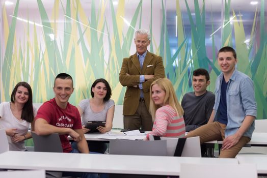 portrait of confident teacher,  students group in background