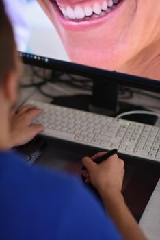 Young graphic designer working on a digital tablet and a computer