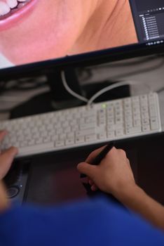 Young graphic designer working on a digital tablet and a computer