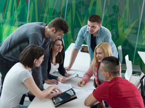 students group study together in school classroom and working together homework project on tablet computer