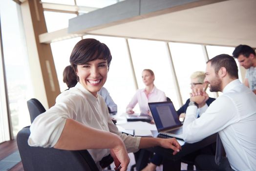 business woman on meeting, people group in background at modern bright office indoors