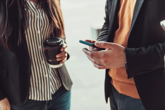 macro photo of young people using the phone during a break from work