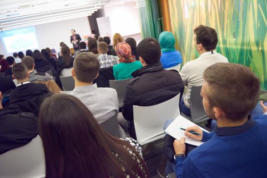 young business people taking notes on education training conference seminar, students at modern classroom