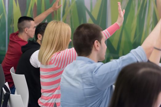 teacher teaching lessons, smart students group raise hands up in school  classroom