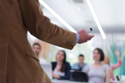 close up of teacher hand with marker while teaching lessons in school  classroom to students