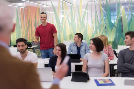 group of students study with professor in modern school classroom