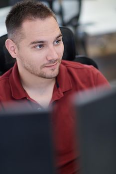 casual business man working on desktop computer in modern open plan startup office interior