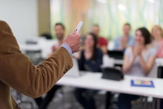 close up of teacher hand with marker while teaching lessons in school  classroom to students