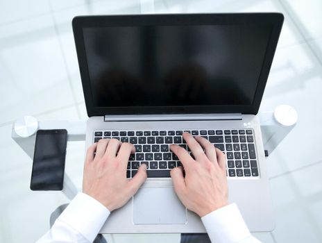 rear view.businessman typing on a laptop.close up