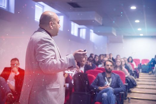 young successful businessman at business conference room with public giving presentations. Audience at the conference hall. Entrepreneurship club