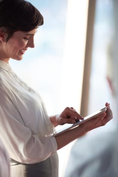 young business woman working on tablet computer at office