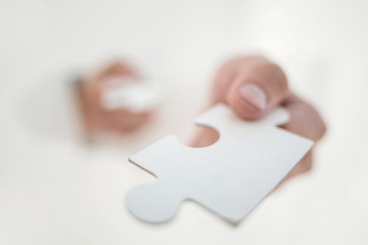 close up.the image of a piece of the puzzle in the hands of a businessman.business concept