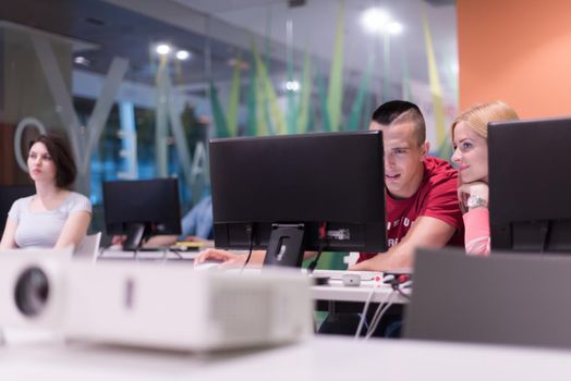 technology students group in computer lab school  classroom working on