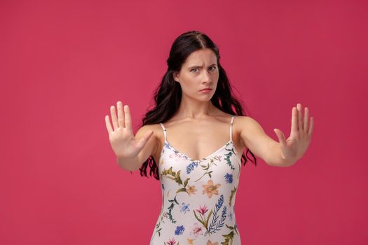 Attractive woman saying thanks but no. Beautiful girl denying proposal, making stop gesture
