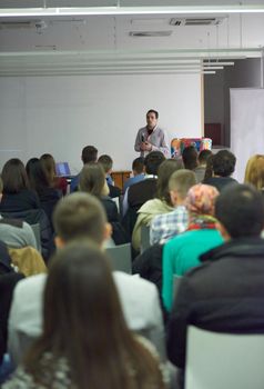 speaker on education conference presentation at modern startup interior
