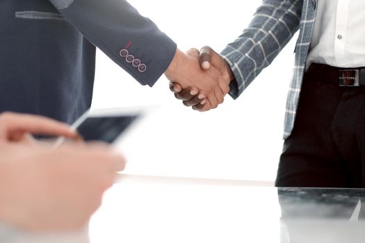 close up. handshake business people standing at the Desk .the concept of cooperation