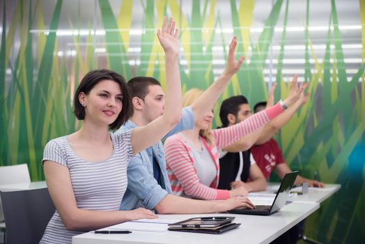 teacher teaching lessons, smart students group raise hands up in school  classroom