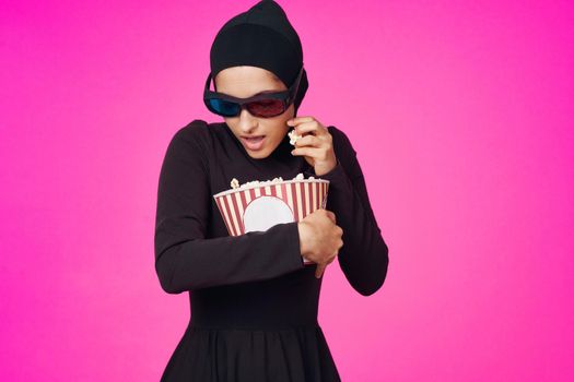 Muslim woman attractive look popcorn glasses movie watching studio lifestyle. High quality photo