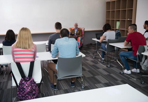 group of students study with professor in modern school classroom