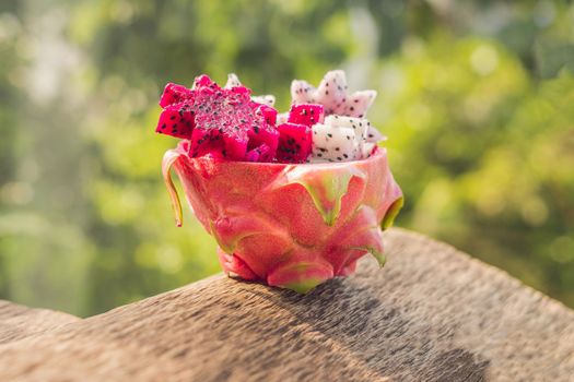 Pieces of sliced dragon fruit in the form of a star on an old withered background.